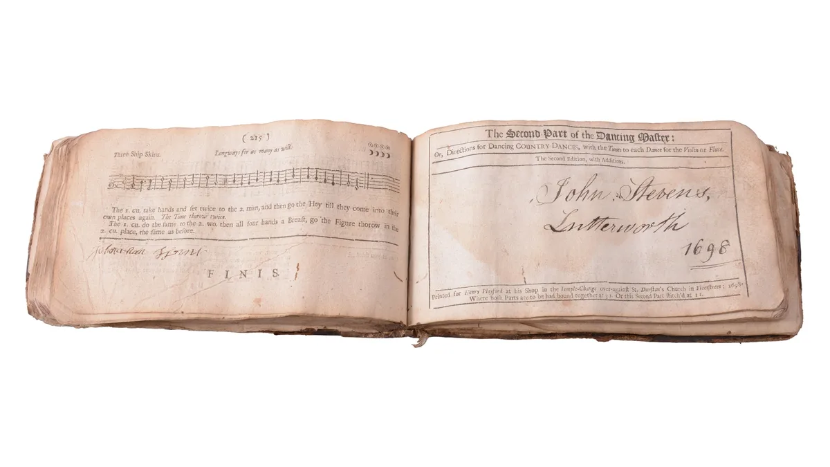 The book open at the title page of The Second Part of the Dancing Master, inscribed 'John Stevens, Lutterworth, 1698'