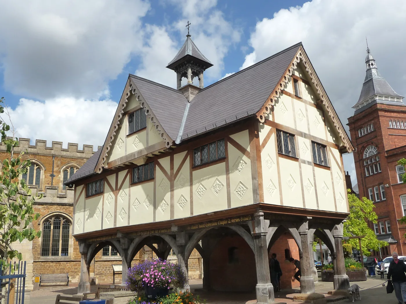 The Old Grammar School in Market Harborough, raised on timber pillars beside St Dionysius Church on Church Square.